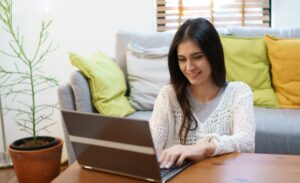Woman using social media on laptop.